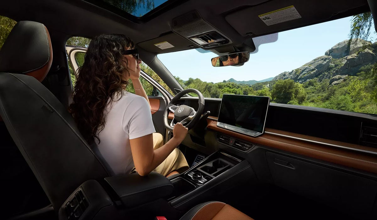 Woman Driving a Volkswagen
